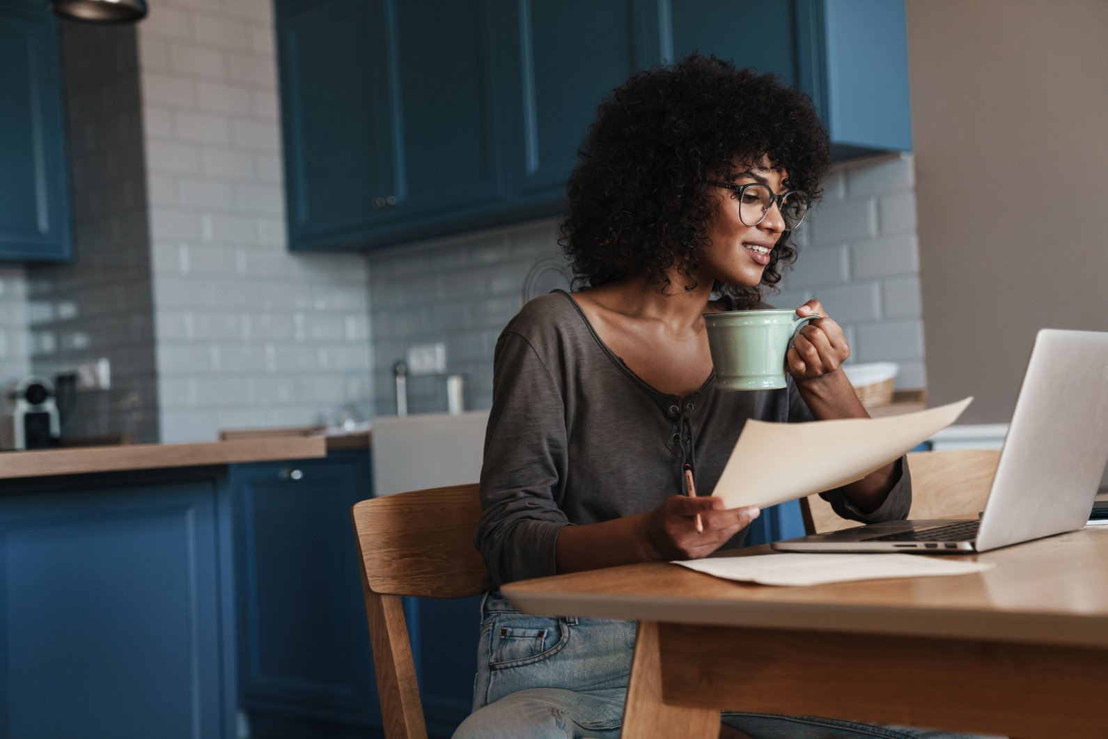 Smiling Young Female Entrepreneur Working on Laptop